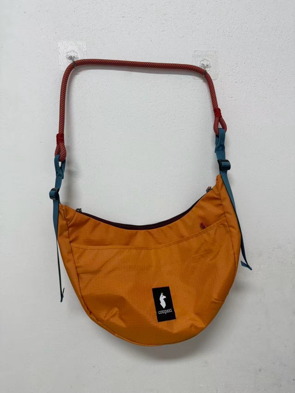 cotopaxi Orange Crescent Shoulder Bag with Teal and Red Accents